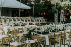 Beautifully arranged outdoor wedding reception featuring floral centerpieces and elegant seating.